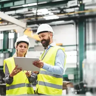 2 warehouse workers using a big tablet