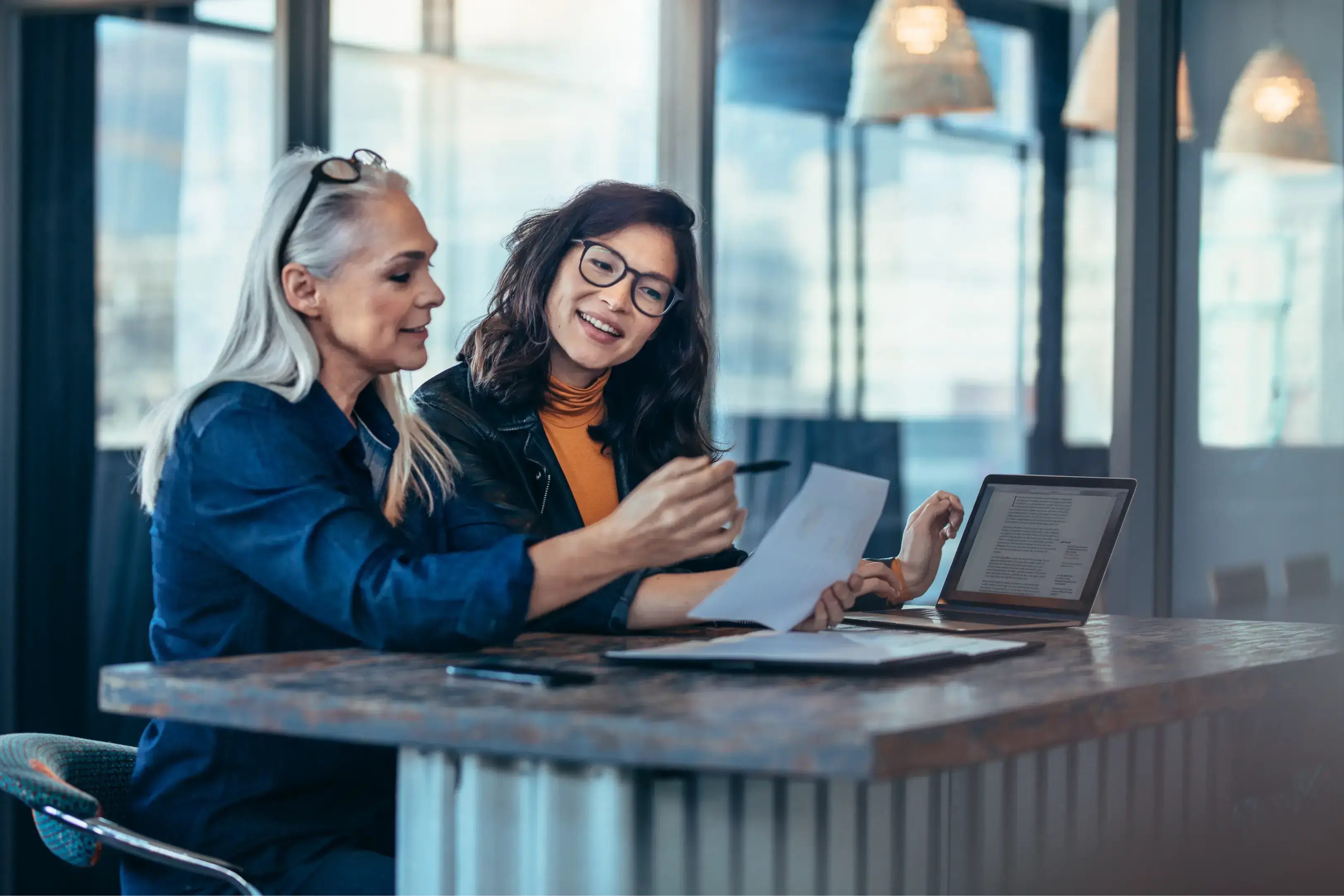 Women working on their devices in an office min